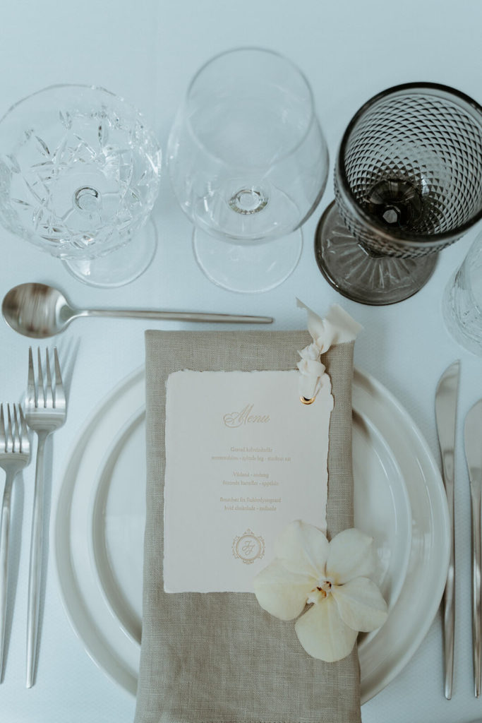 Bryllupsbord meed gråt vinglas og naturfarvet hørserviet, churstill stel og sølv bestik